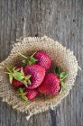 Fresh strawberries on sackcloth — Stock Photo