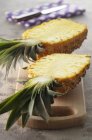 Halved pineapple on board — Stock Photo