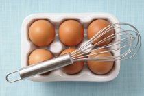 Brown eggs in porcelain egg box — Stock Photo