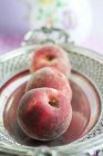 Fresh peaches in silver dish — Stock Photo