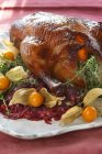 Stuffed duck with tangerines and onions — Stock Photo