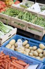 Several wooden crates of vegetables at the market — Stock Photo