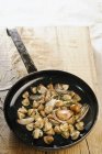 Elevated view of fried mushrooms with herbs in a frying pan — Stock Photo