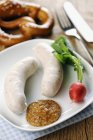 Veal sausages with sweet mustard — Stock Photo