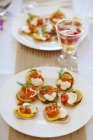 Mini pancakes with lemon slices and salmon — Stock Photo