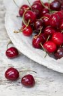 Fresh cherries on stone plate — Stock Photo