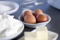Vista de cerca de huevos marrones con quark y mantequilla - foto de stock
