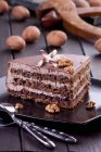 Walnut layer cake with chocolate curl — Stock Photo