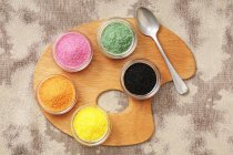 Colored sugar in small bowls — Stock Photo