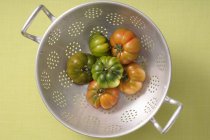 Fresh tomatoes in colander — Stock Photo