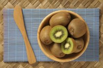 Kiwis in wooden bowl — Stock Photo