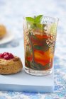 Closeup view of iced tea with ice cubes and mint — Stock Photo