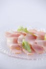 Sliced ham and rocket leaves — Stock Photo
