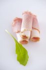 Rolled ham slices and rocket leaf — Stock Photo