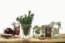 Sill life with assorted herbs and spices in glass containters — Stock Photo