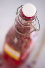 Closeup view of closed bottle of lavender sauce — Stock Photo