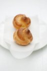 Mini cream puffs on plate — Stock Photo