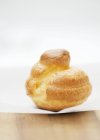 Closeup view of cream puff pastry on parchment paper — Stock Photo