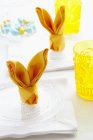 Closeup view of napkins folded into Easter bunnies — Stock Photo