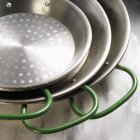 Closeup view of three green handled pans — Stock Photo