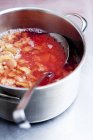 Closeup view of stewed rhubarb with a skimmer in a saucepan — Stock Photo