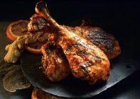 Closeup view of barbecued turkey legs with orange and ginger — Stock Photo