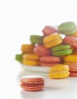 Colourful macaroons and plate — Stock Photo