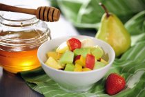 Fruit salad with honey — Stock Photo