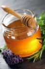 Honey jar with dipper — Stock Photo