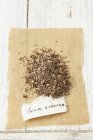 Elevated view of dried wood avens on paper with label — Stock Photo