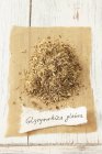 Closeup view of dried liquorice root heap with tag — Stock Photo