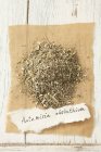 Closeup top view of dried wormwood on paper with tag — Stock Photo