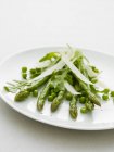 Asparagas and peas with parmesan — Stock Photo