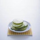 Lime slices on white plate — Stock Photo