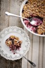 Top view of mixed berry crisp on a white plate with a fork — Stock Photo