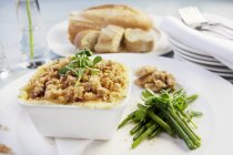 Closeup view of fish pie with herb, green beans and bread — Stock Photo