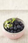 Blueberries in sieve in bowl — Stock Photo
