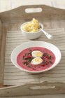 Botwinka - Polish beetroot soup with egg  on white plate in wooden tray — Stock Photo