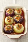 Closeup view of stuffed onions with herbs in baking dish — Stock Photo