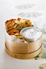 Grilled vegetables with dip in wooden tin on white surface — Stock Photo