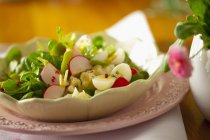Colourful salad with quail's eggs in white plate — Stock Photo
