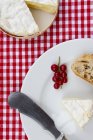Camembert with baguette on plate — Stock Photo