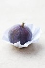 Fresh ripe fig on paper — Stock Photo