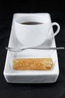 Coffee with small brandy snap tuille — Stock Photo