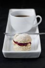 Cup of coffee with small scone — Stock Photo
