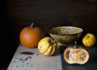 Fresh pumpkins with bowl — Stock Photo