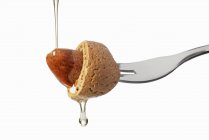 Almond on fork with oil — Stock Photo