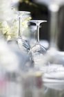 Closeup view of upturned wine glasses on a laid table — Stock Photo