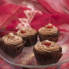 Chocolate cupcakes with glace cherries — Stock Photo