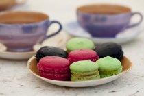 Colourful macaroons on plate — Stock Photo